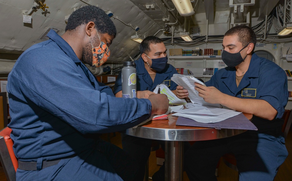 Aviation Ordnancemen Study For Air Warfare Exam In Library Aboard Aircraft Carrier USS Nimitz CVN 68