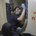 Information Systems Technician Paints Kinfeedge Aboard Aircraft Carrier USS Nimitz CVN 68