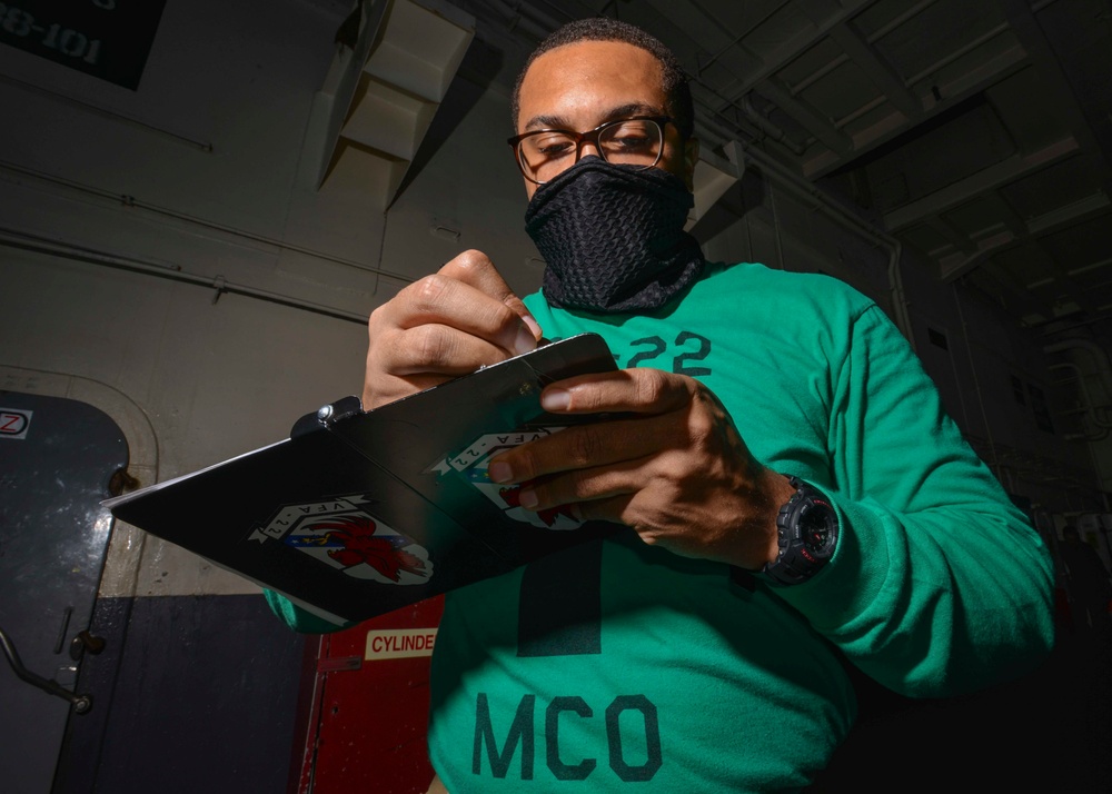 Material Control Officer Conducts Hangar Bay Walkthrough In Hangar Bay Aboard Aircraft Carrier USS Nimitz CVN 68