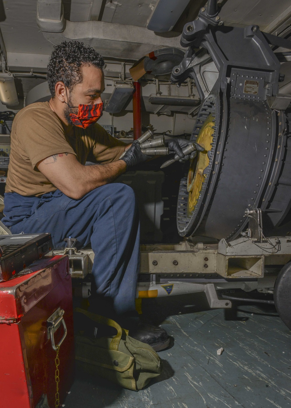 Aviation Ordnanceman Troubleshoots Binding Of 20MM Drum Aboard Aircraft Carrier USS Nimitz CVN 68