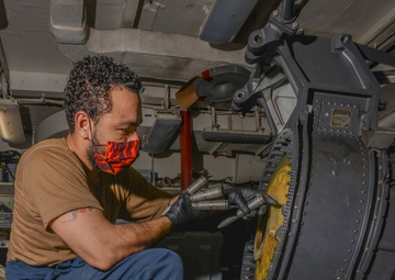 Aviation Ordnanceman Troubleshoots Binding Of 20MM Drum Aboard Aircraft Carrier USS Nimitz CVN 68