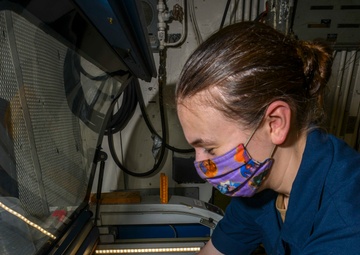 Machinery Repairman Engraves Signs With Laser Engraver Aboard Aircraft Carrier USS Nimitz CVN 68