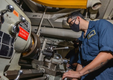 Machinery Repairman Operates Lathe Aboard Aircraft Carrier USS Nimitz CVN 68