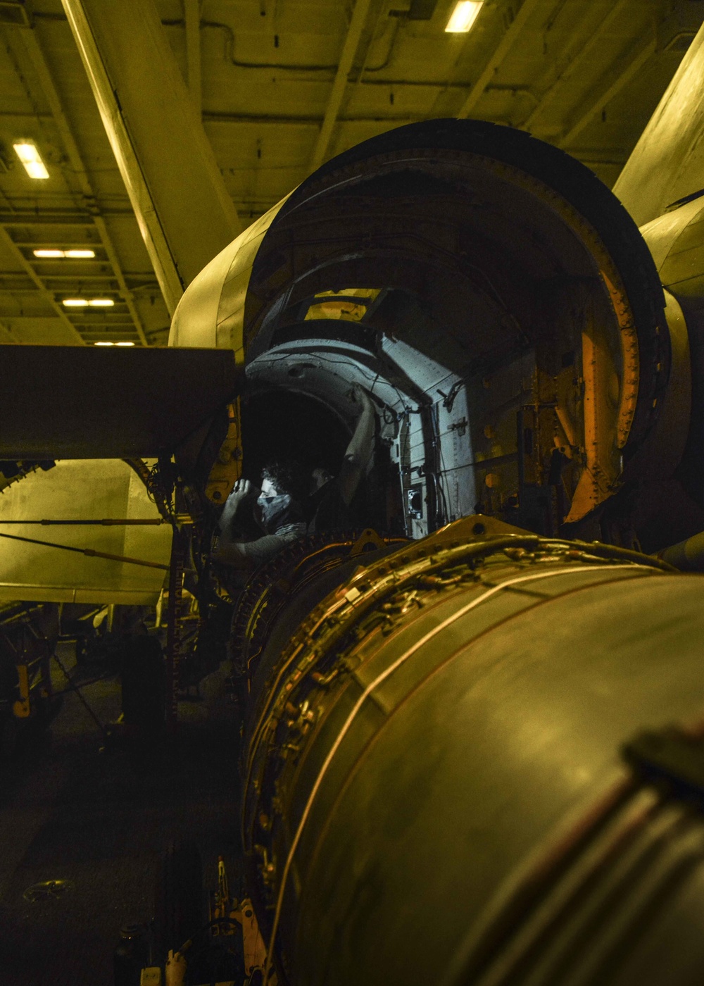 Aviation Structural Mechanics Perform Engine Bay Maintenance In Hangar Bay Aboard USS Nimitz CVN 68