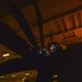 Aviation Machinist's Mate Installs Brush Block Assembly On Carrier Airborne Early Warning Squadron VAW 116 Sun Kings E-2C Hawkeye In Hangar Bay Aboard Aircraft Carrier USS Nimitz CVN 68