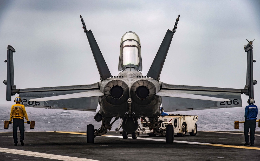 Sailors Taxi An F/A-18E Super Hornet Across The Flight Deck Aboard Nimitz