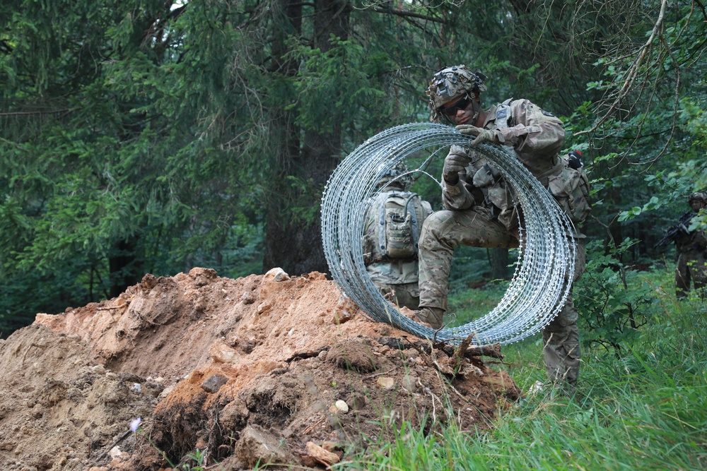 Lay concertina wire barriers