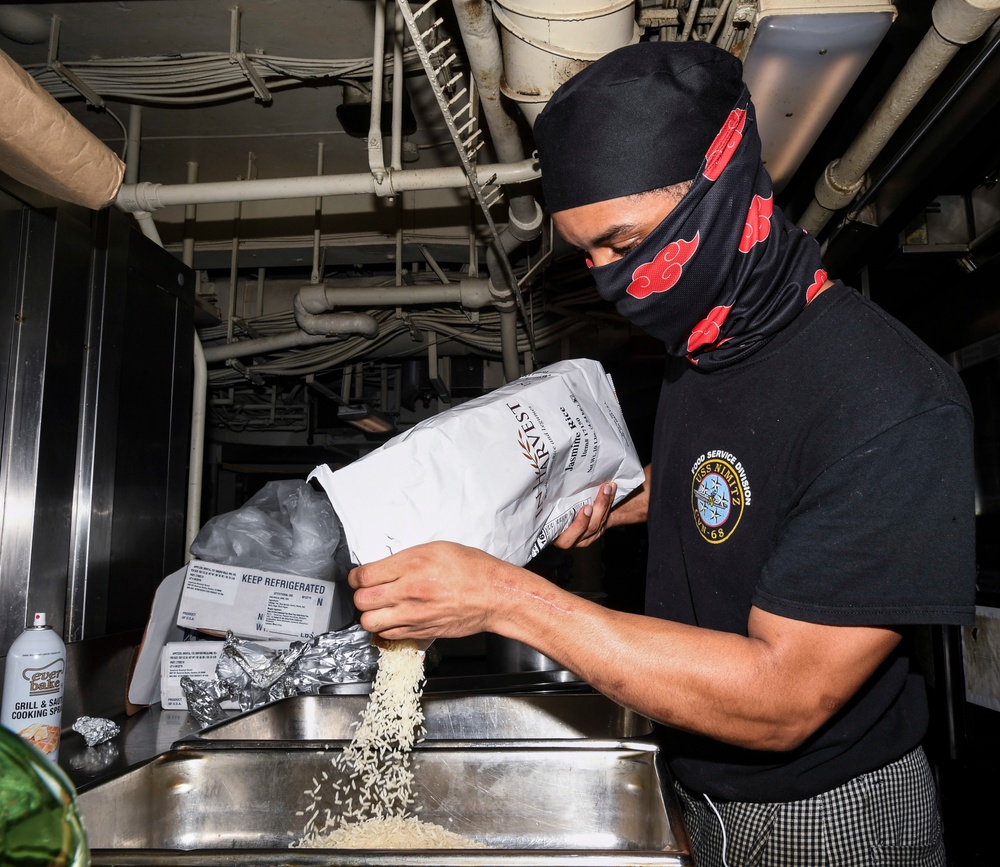 Sailors Participate In Mongolian Grill Night Aboard Nimitz