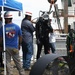 A USACE Diver is assisted with his equipment after completing his dive