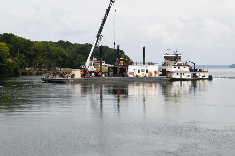 A USACE barge transport an 18 tone debris screen to shore after lifting from the water at Wilson Lock in Florence Ala.