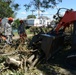 CE Airmen clear trees with skid loader