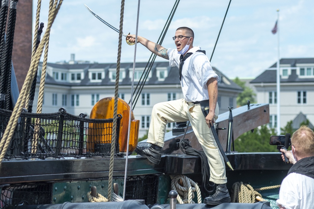 Boatswain’s Mate 1st Class Corey Van-Beveren participates in a reenactment of USS Constitution’s victorious battle