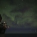 The Aurora Borealis Appears over the Arleigh Burke-class Guided-Missile Destroyer USS Thomas Hudner (DDG 116), During Operation Nanook-Tuugaalik