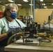 Martha Hunter connects a hydraulic component to a testing apparatus for a Stryker vehicle