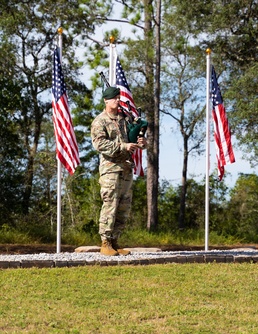 Special Forces Soldier plays bagpipes during ceremony.