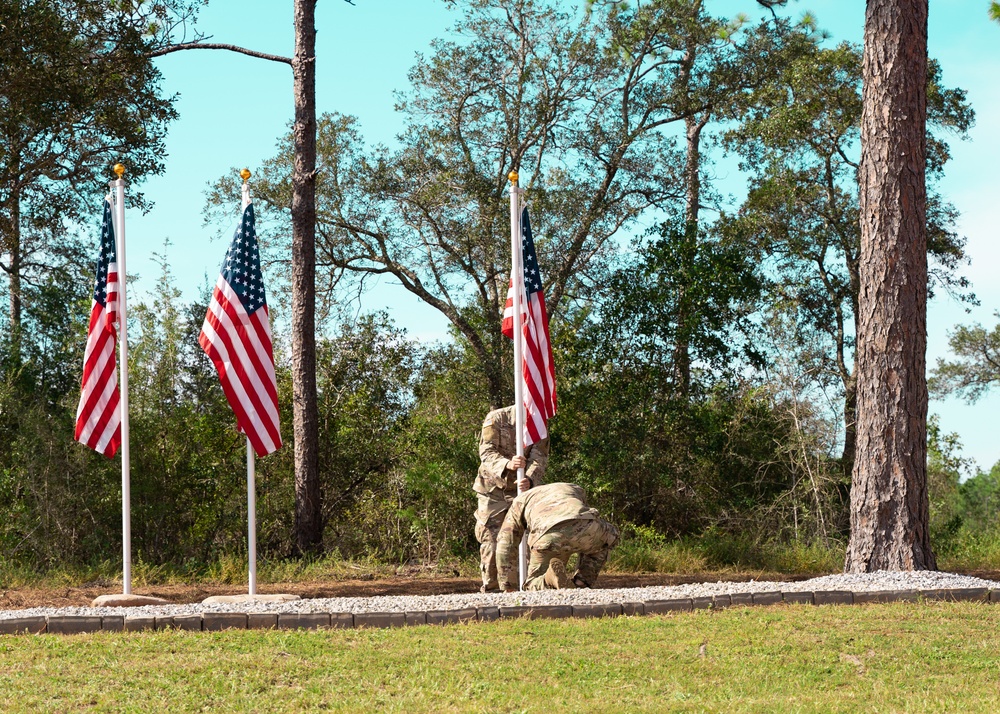 7th Special Forces soldiers places the flag and rock during the ceremony