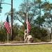 7th Special Forces soldiers places the flag and rock during the ceremony