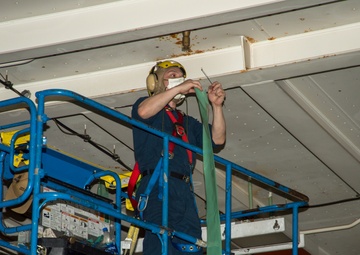 USS Carl Vinson (CVN 70) Sailor Puts Coverings Over AFFF Sprinkler Heads