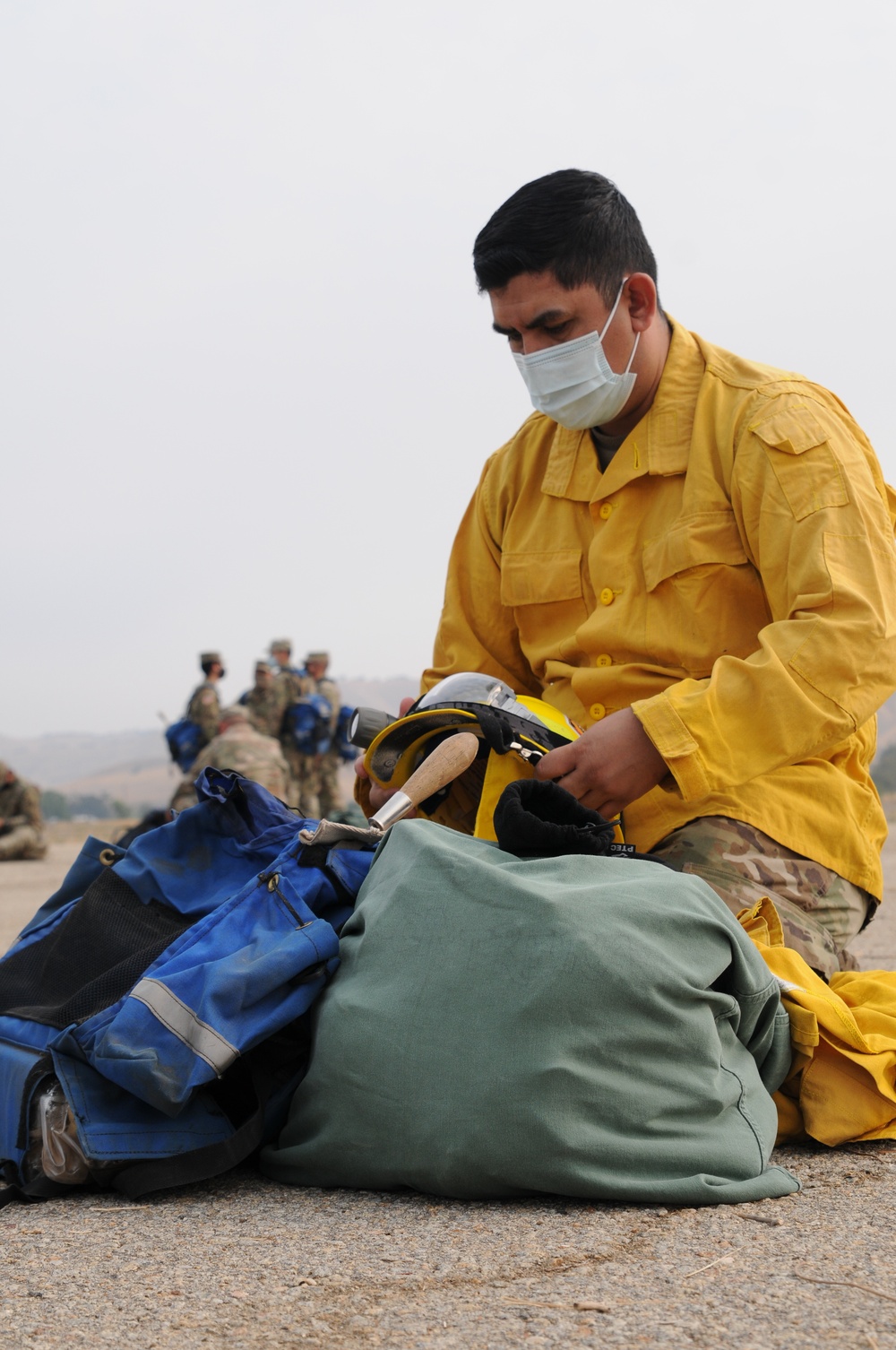 California Army National Guard Soldiers receive training from Cal Fire officers on the proper wear and use of their personal protective equipment