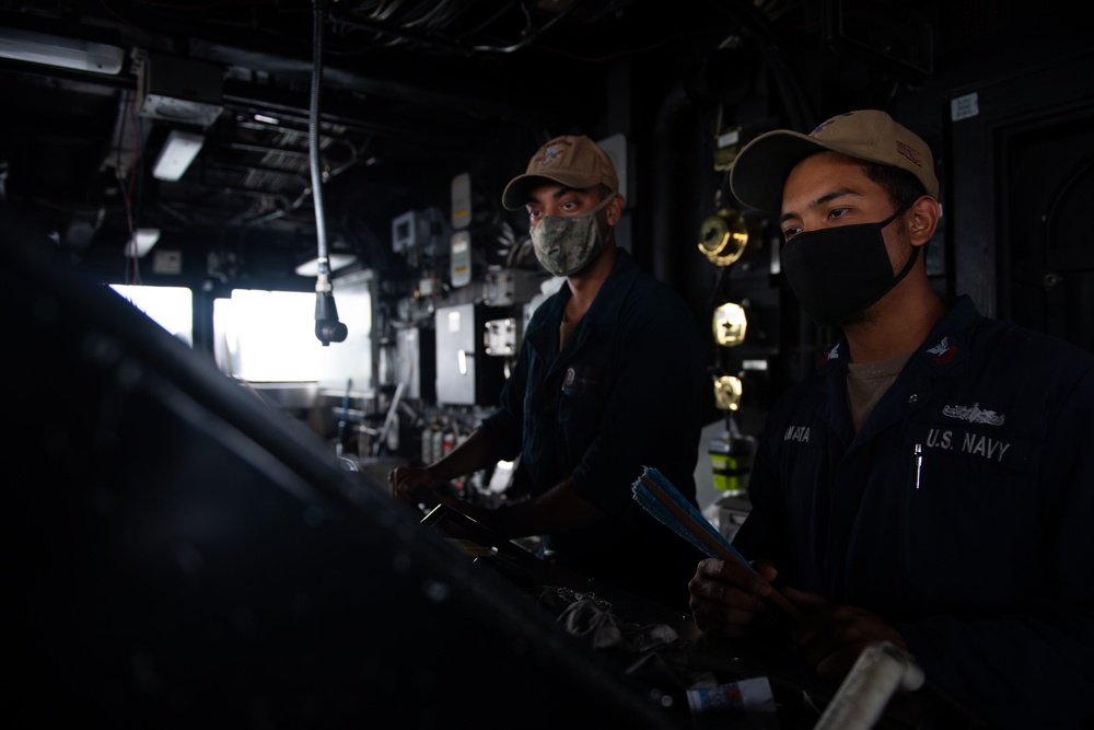 USS Princeton Sailors stand watch at the ship's helm