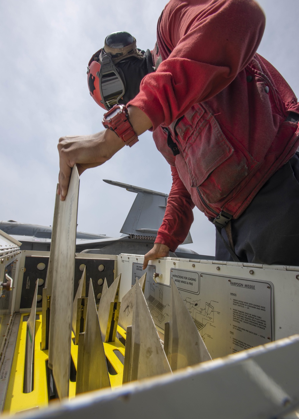 Aviation Ordnanceman Inspects Missile Wings And Fins On Flight Deck Aboard Aircraft Carrier USS Nimitz CVN 68