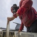 Aviation Ordnanceman Inspects Missile Wings And Fins On Flight Deck Aboard Aircraft Carrier USS Nimitz CVN 68