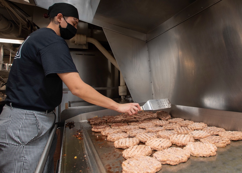 Sailor Grills Burgers In Galley