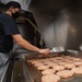 Sailor Grills Burgers In Galley