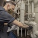 Sailor Inspects A Water Heater For Steam Leaks