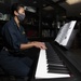 Officer Plays Piano During Brunch Aboard Aircraft Carrier USS Nimitz CVN 68