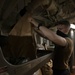 Aviation Ordnanceman Empties Paper Into Pulper Aboard Aircraft Carrier