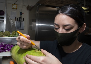 Culinary Specialist Prepares Squash Decoration Aboard Aircraft Carrier USS Nimitz CVN 68