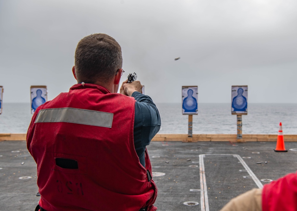 command master chief of the aircraft carrier USS Nimitz (CVN 68), from Tucson, Ariz., participates in a small arms live fire exercise aboard Nimitz