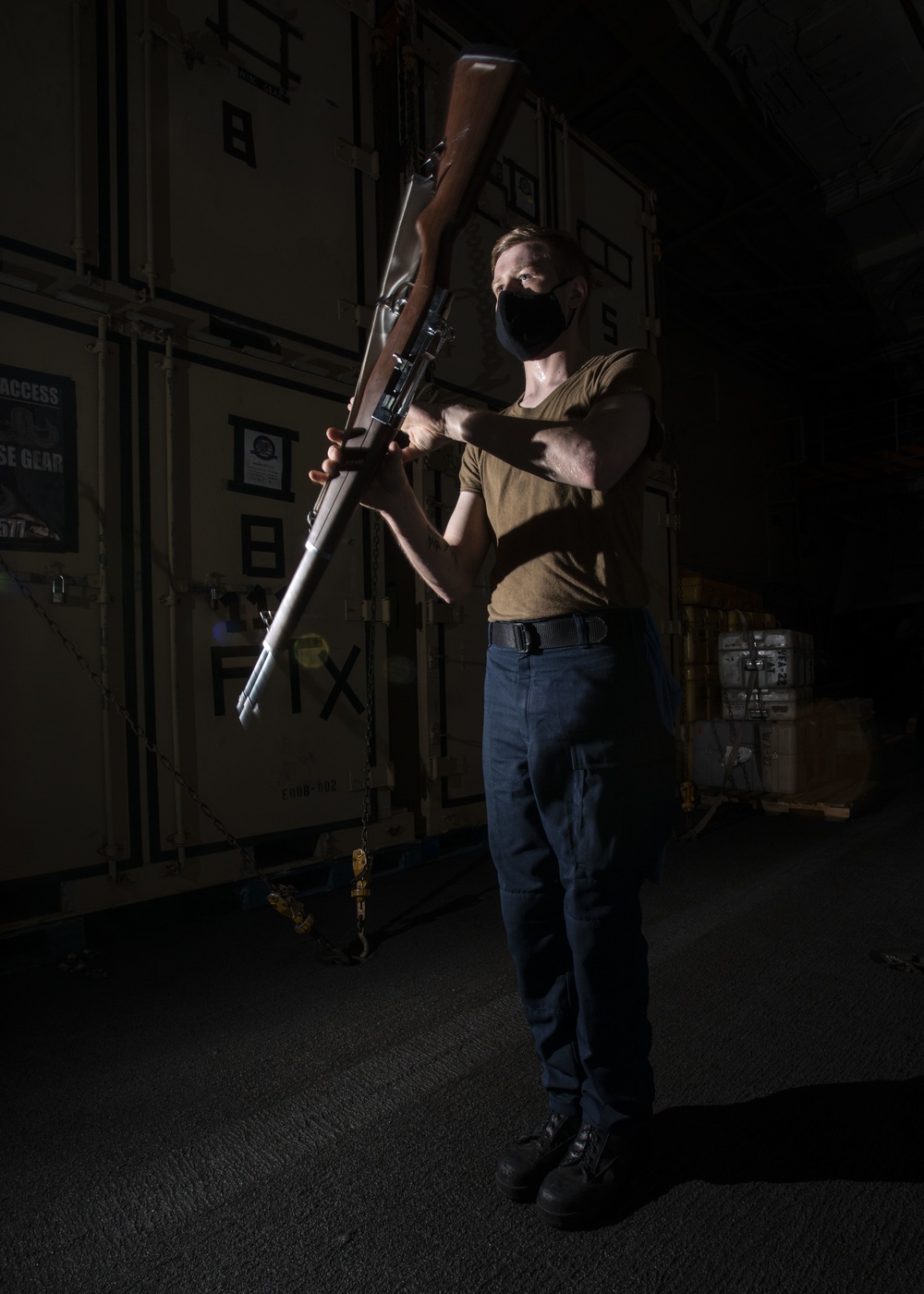 Aviation Boatswain's Mate (Handling) Spins Ceremonial Rifle During Nimitz Honor Guard Practice In Hangar Bay Aboard Aircraft Carrier USS Nimitz CVN 68