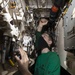 Aviation Structural Mechanic Troubleshoots Hydraulic Line In Hangar Bay Aboard Aircraft Carrier USS Nimitz CVN 68