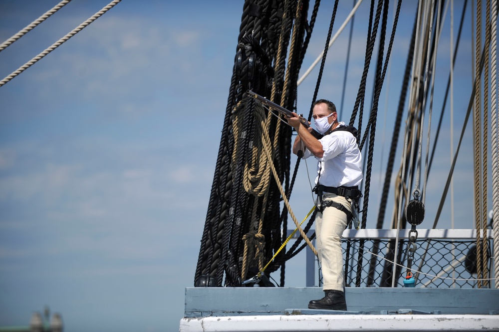 Master-At-Arms 1st Class Travis Hagerty fires a musket aboard USS Constitution
