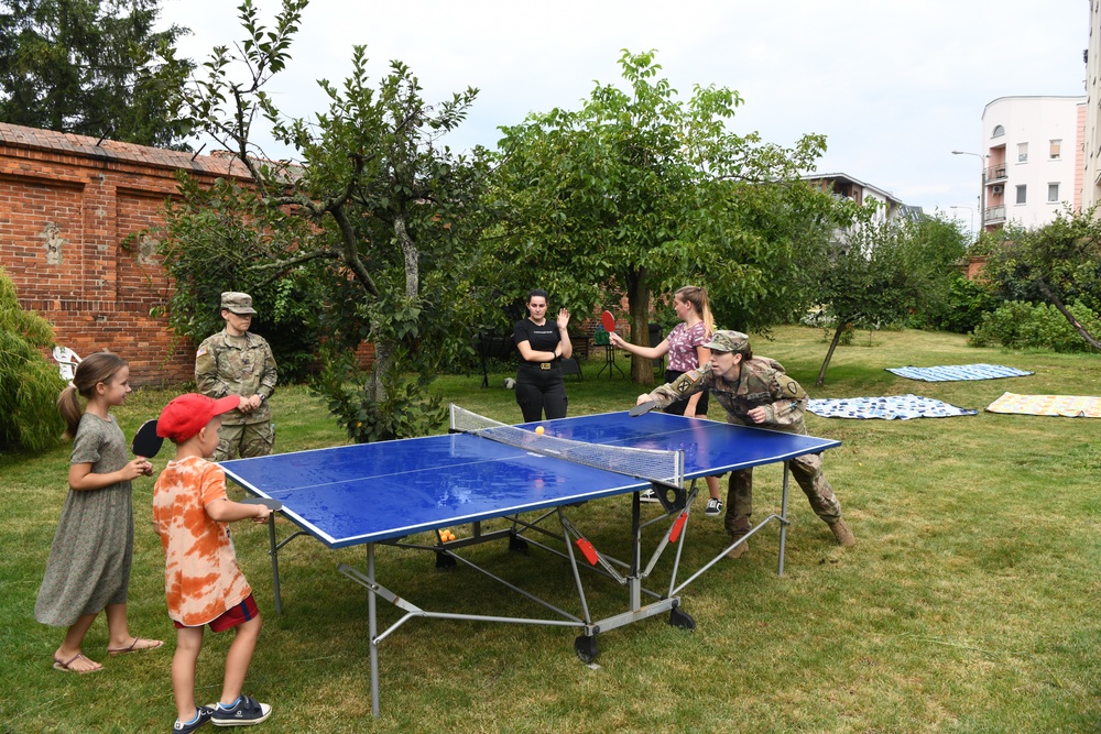 Soldiers Playing Ping Pong with Polish Children
