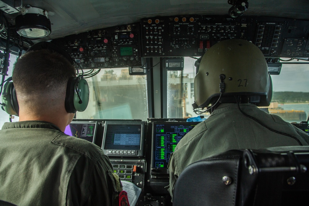 Landing craft, air cushion hovercrafts on load 31st MEU trucks and heavy equipment