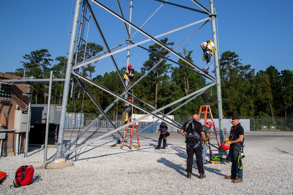 Electronic maintenance teams practice tower climbing to keep base communications flowing