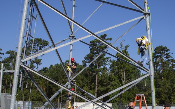 Electronic maintenance teams practice tower climbing to keep base communications flowing