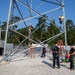Electronic maintenance teams practice tower climbing to keep base communications flowing