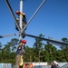 Electronic maintenance teams practice tower climbing to keep base communications flowing