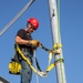 Electronic maintenance teams practice tower climbing to keep base communications flowing
