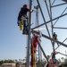 Electronic maintenance teams practice tower climbing to keep base communications flowing