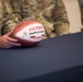 Team Whiteman Airman displays Kansas City Chiefs football gift for virtual Military Appreciation Day event