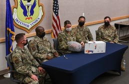 Team Whiteman Airman opens gift from Kansas City Chiefs with leadership