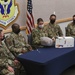 Team Whiteman Airman opens gift from Kansas City Chiefs with leadership