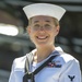 Quartermaster 2nd Class Rachel Dill poses for a photo in front of USS Constitution