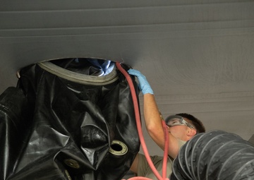 Multi-unit fuel system specialists team changes C-130 auxiliary fuel cell