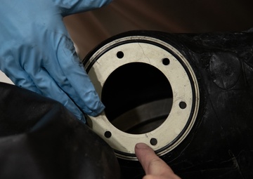 Multi-unit fuel system specialists team changes C-130 auxiliary fuel cell